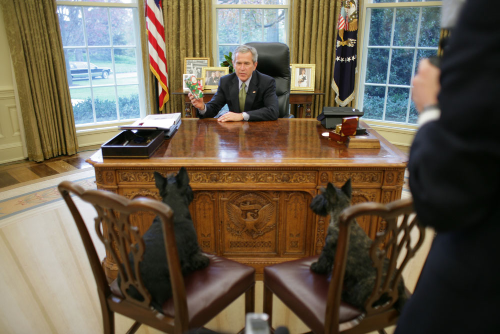 President George W. Bush Sits Across from Barney and Miss Beazley in the Oval Office